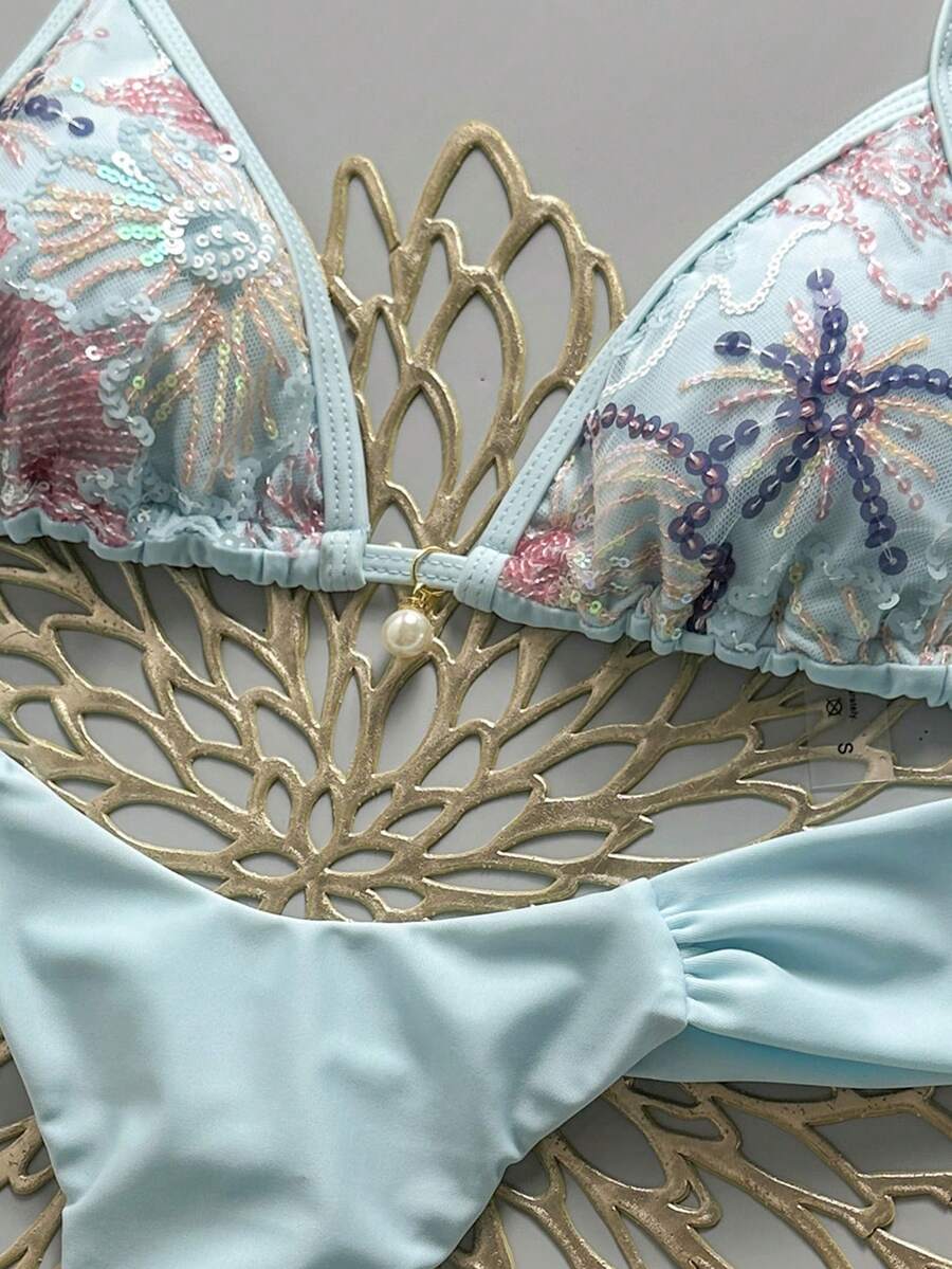 Women's 2-piece triangle cup bikini set in solid color featuring woven pearl shell decoration, halter neckline, and high-waist side-tie ruched bottoms.