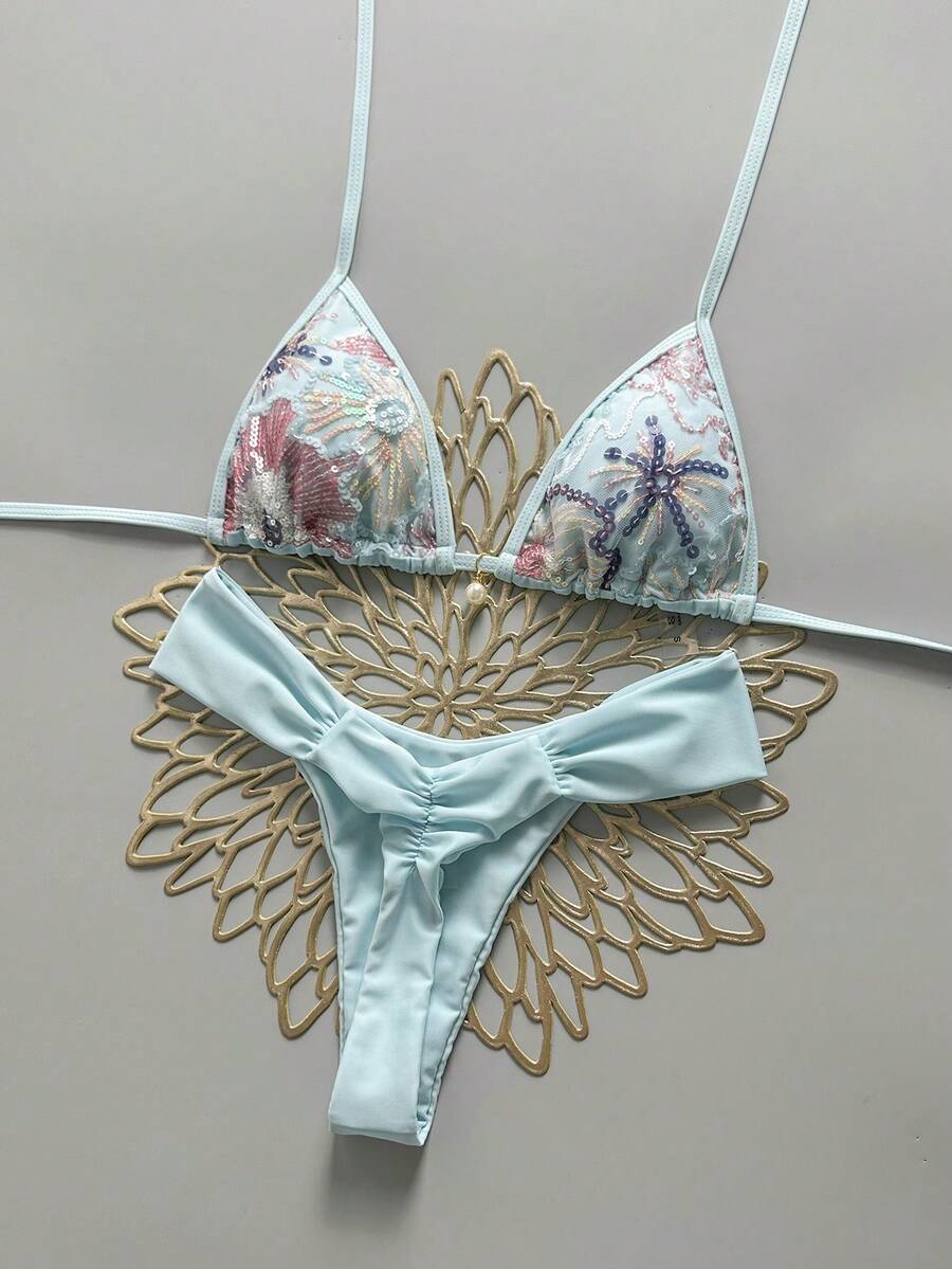 Women's 2-piece triangle cup bikini set in solid color featuring woven pearl shell decoration, halter neckline, and high-waist side-tie ruched bottoms.