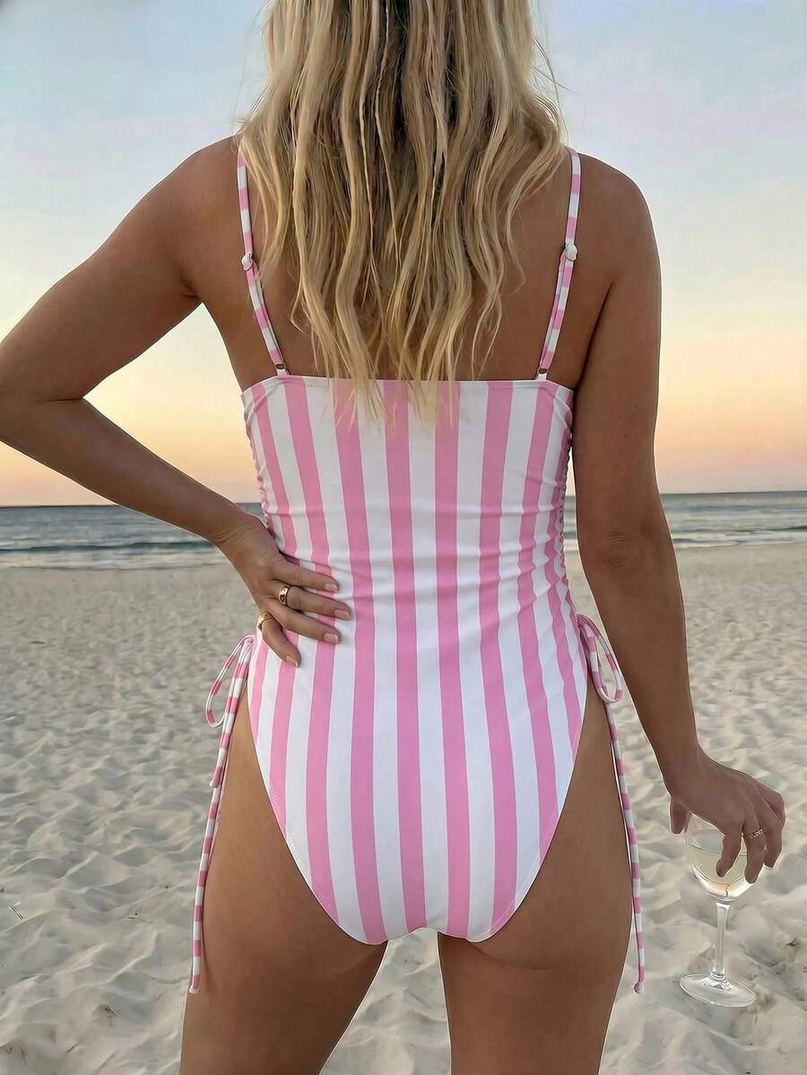 Women's blue backless one-piece swimsuit featuring spaghetti straps, wireless bra with removable padding, and drawstring details.