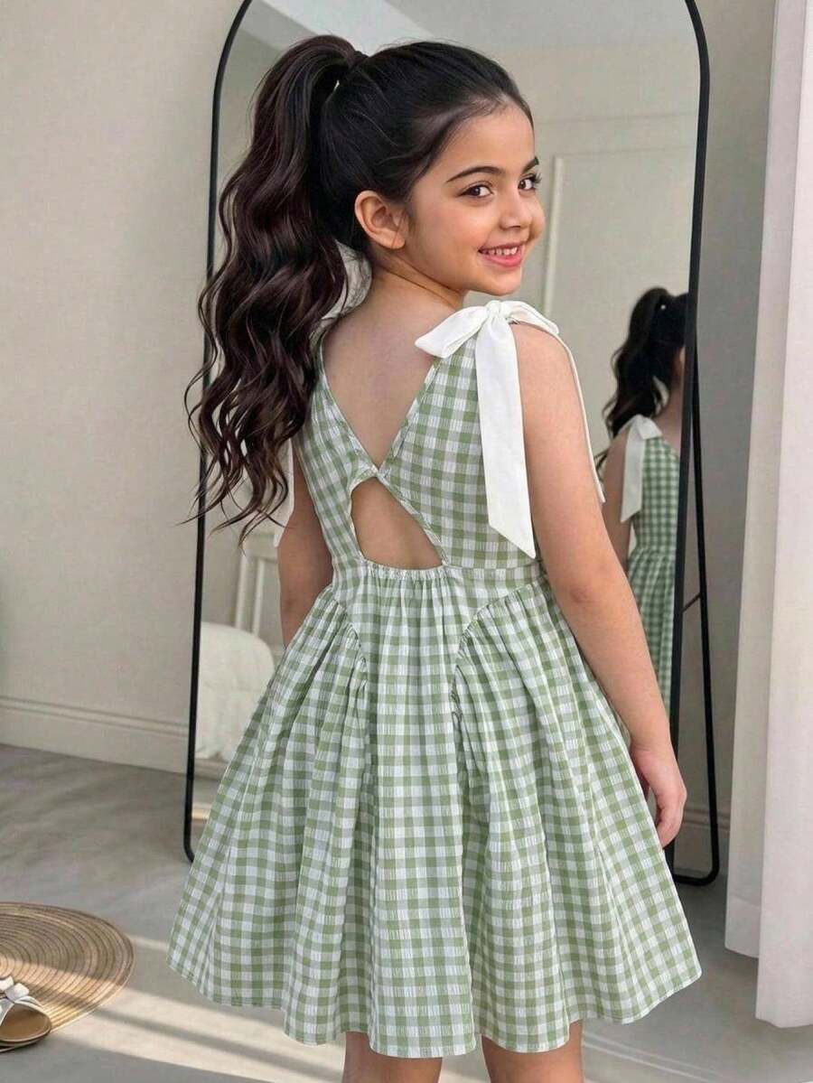 Black and white polka dot sleeveless A-line dress for tween girls featuring a scoop neck, high waist, and flared hem.