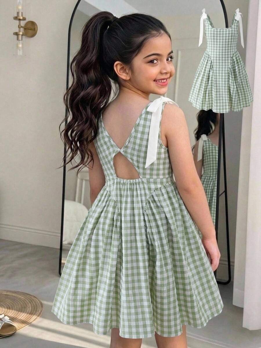 Black and white polka dot sleeveless A-line dress for tween girls featuring a scoop neck, high waist, and flared hem.
