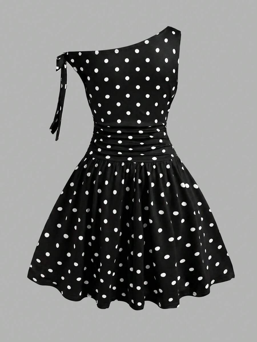Tween girl wearing an apricot asymmetrical tiered sleeveless party dress with an A-line silhouette.