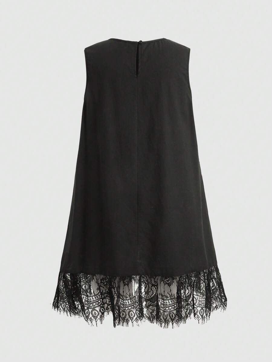 Tween girl wearing a sleeveless black tunic dress featuring a round neck, contrast lace details, and a straight hem.