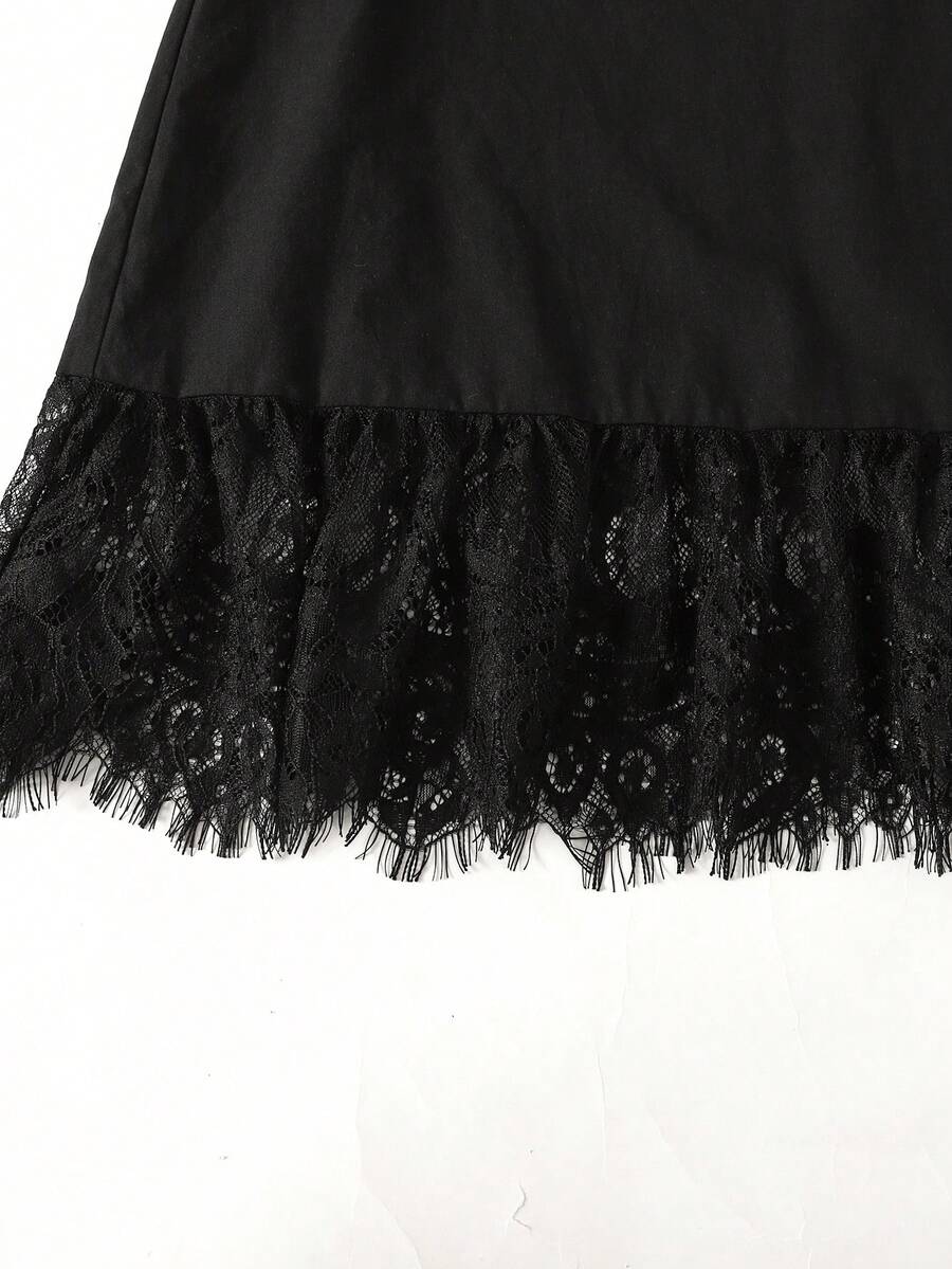 Tween girl wearing a sleeveless black tunic dress featuring a round neck, contrast lace details, and a straight hem.