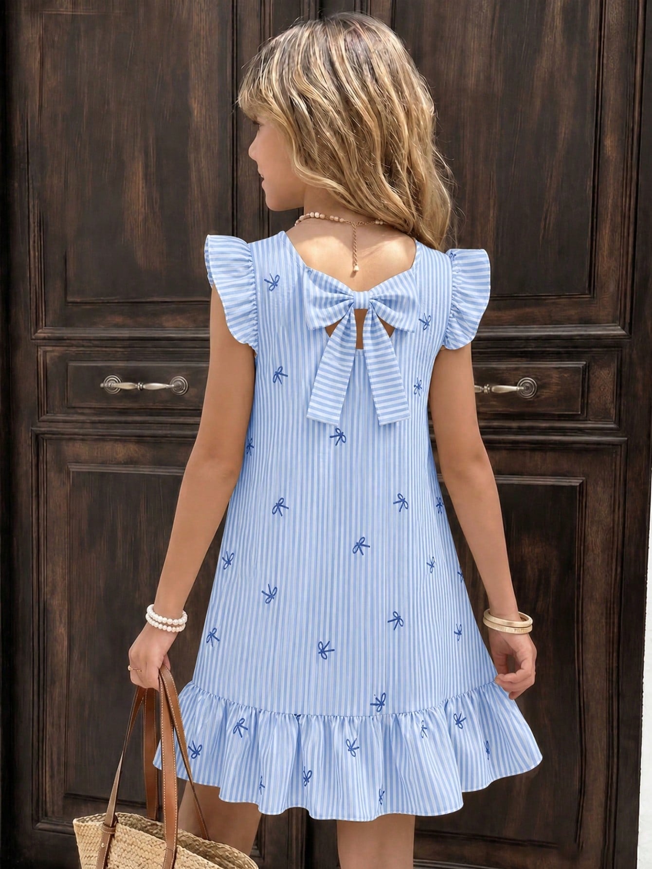 Tween girls apricot vacation midi dress featuring a round neck, cut out details, ruffle flounce accents, and geometric pattern.