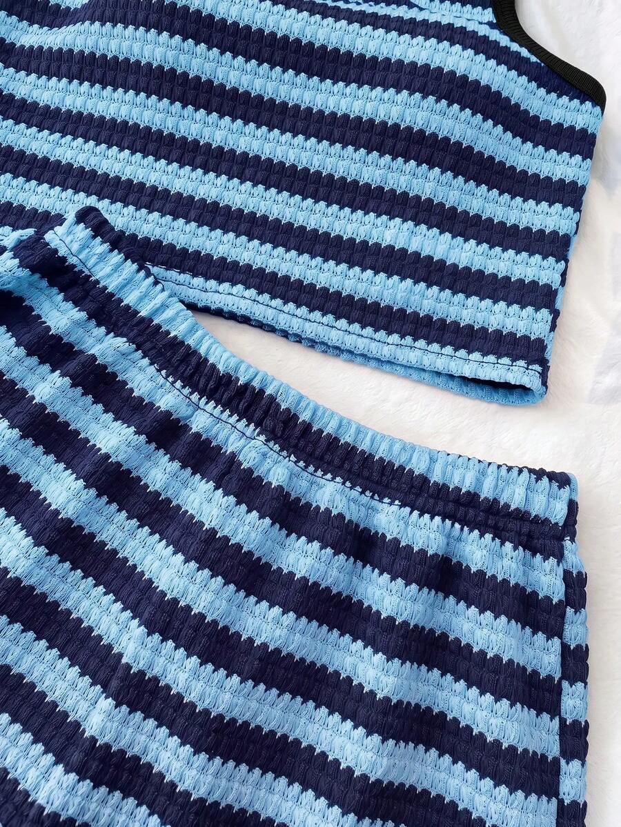 Tween girls black and white two-piece casual summer outfit featuring a rib-knit cropped top with round neck and matching shorts with contrast piping.