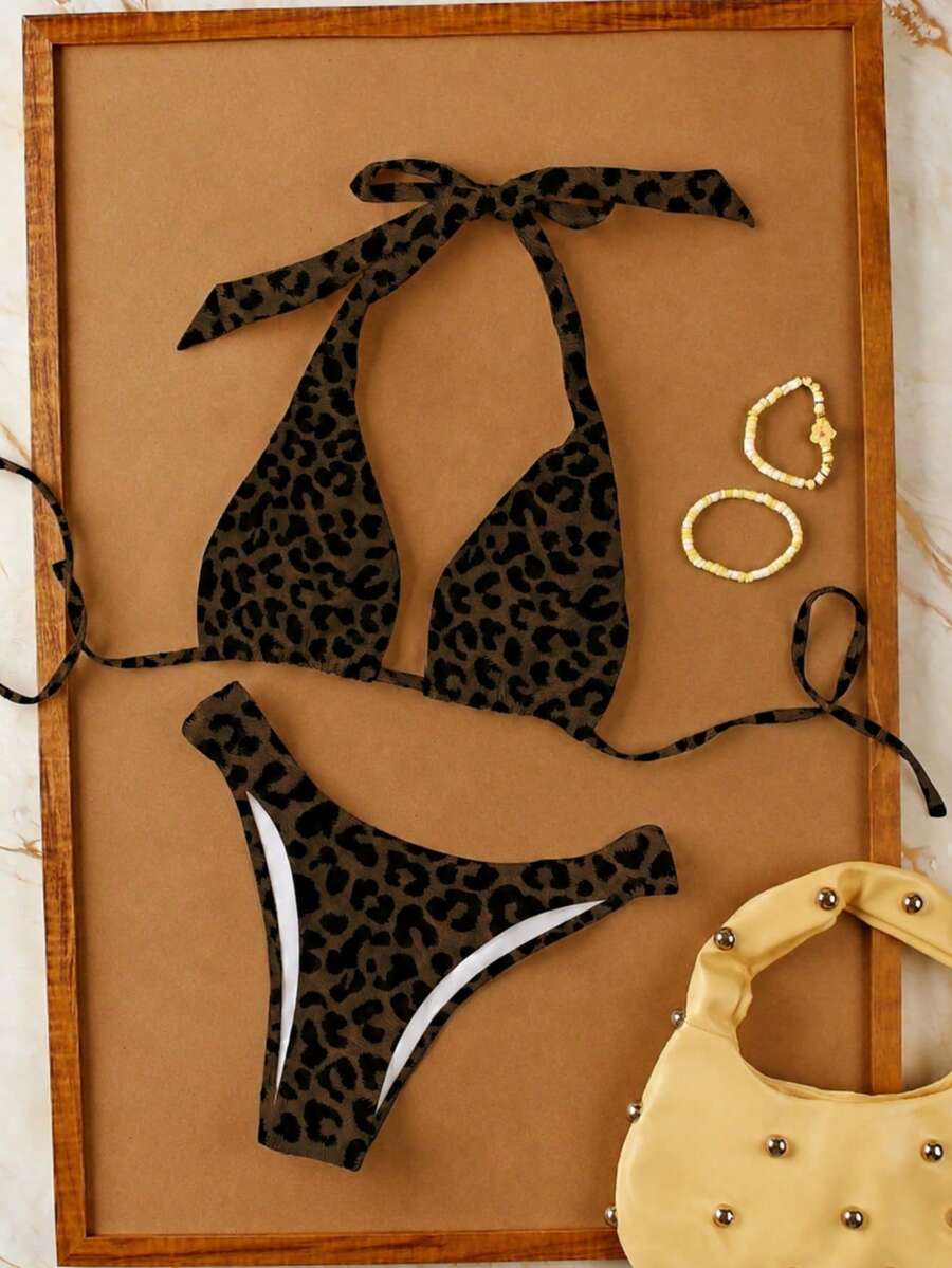 Women's halter neck bikini swimwear set featuring a wireless bra top with removable padding and mid waist bikini bottom.