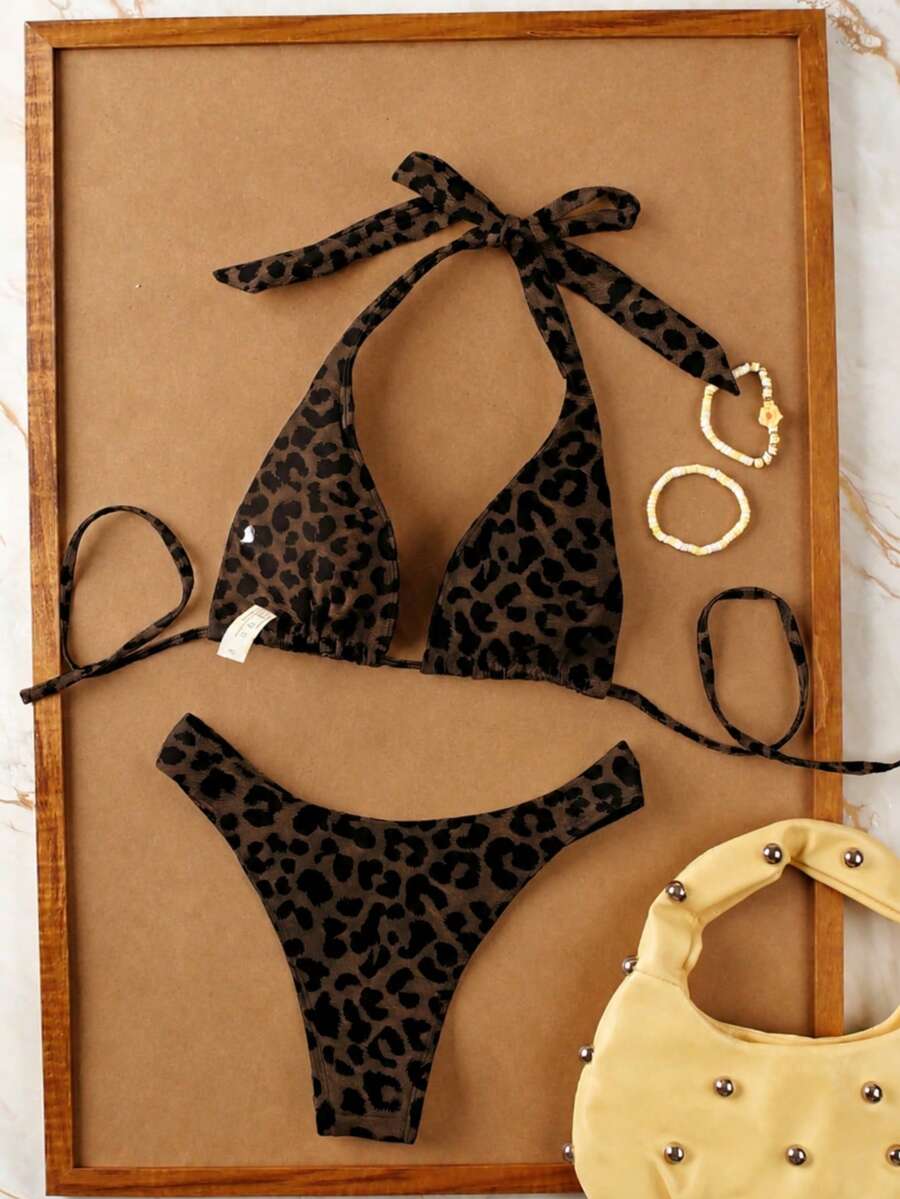 Women's halter neck bikini swimwear set featuring a wireless bra top with removable padding and mid waist bikini bottom.