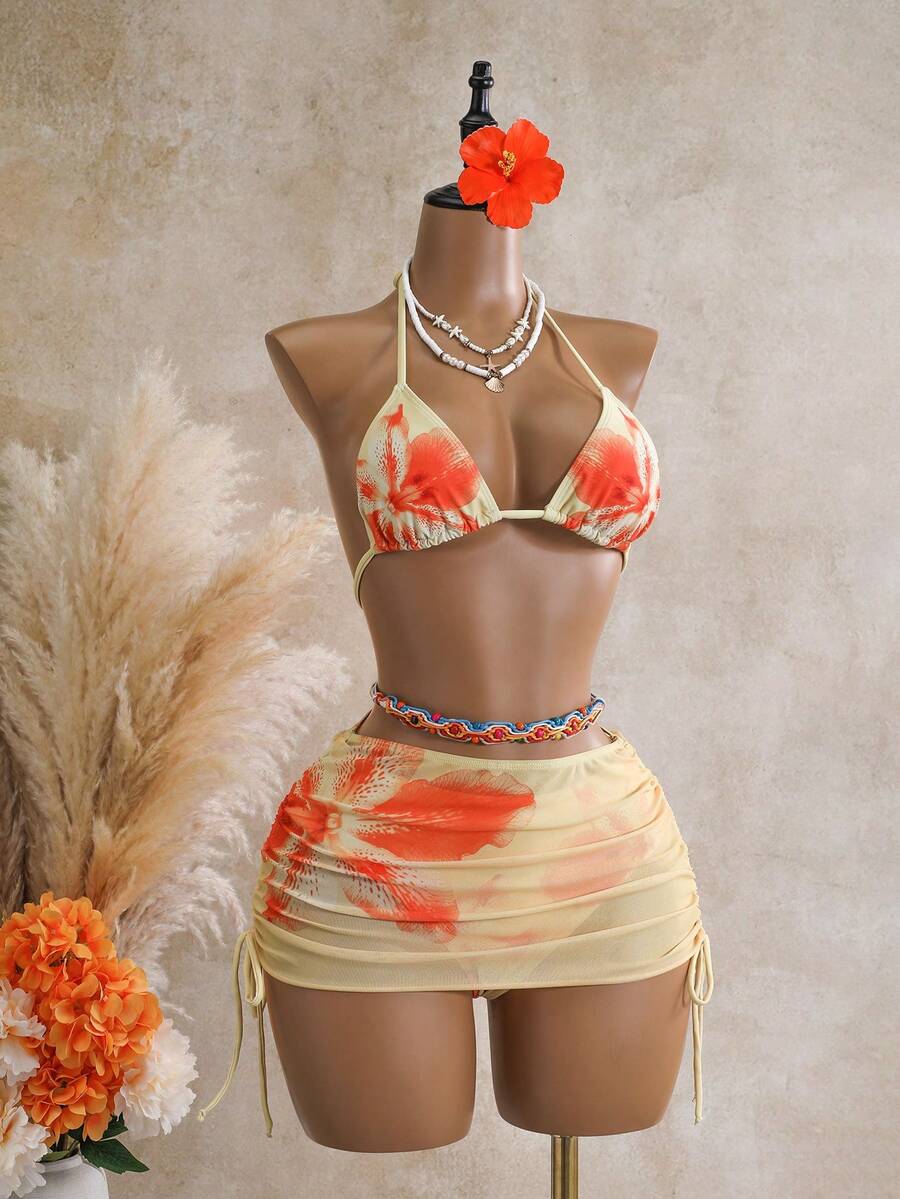 Women's black 3-piece bikini set featuring a halter triangle top with removable padding, high-waisted bottoms, and a knee-length mesh skirt with tie details.