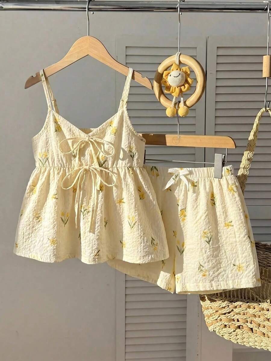 Tween girls 2-piece summer vacation set featuring a multicolored geometric print sleeveless camisole top with bow knot detail and matching elastic waist shorts.