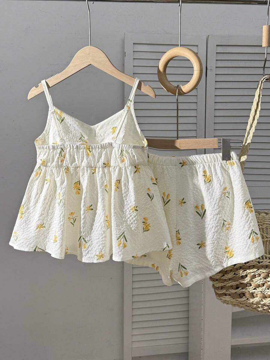 Tween girls 2-piece summer vacation set featuring a multicolored geometric print sleeveless camisole top with bow knot detail and matching elastic waist shorts.