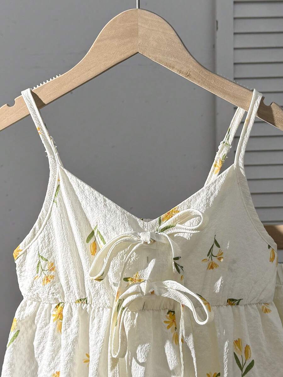 Tween girls 2-piece summer vacation set featuring a multicolored geometric print sleeveless camisole top with bow knot detail and matching elastic waist shorts.