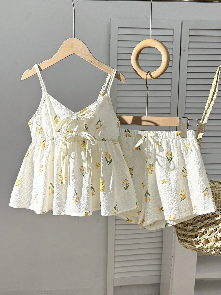 Tween girls 2-piece summer vacation set featuring a multicolored geometric print sleeveless camisole top with bow knot detail and matching elastic waist shorts.