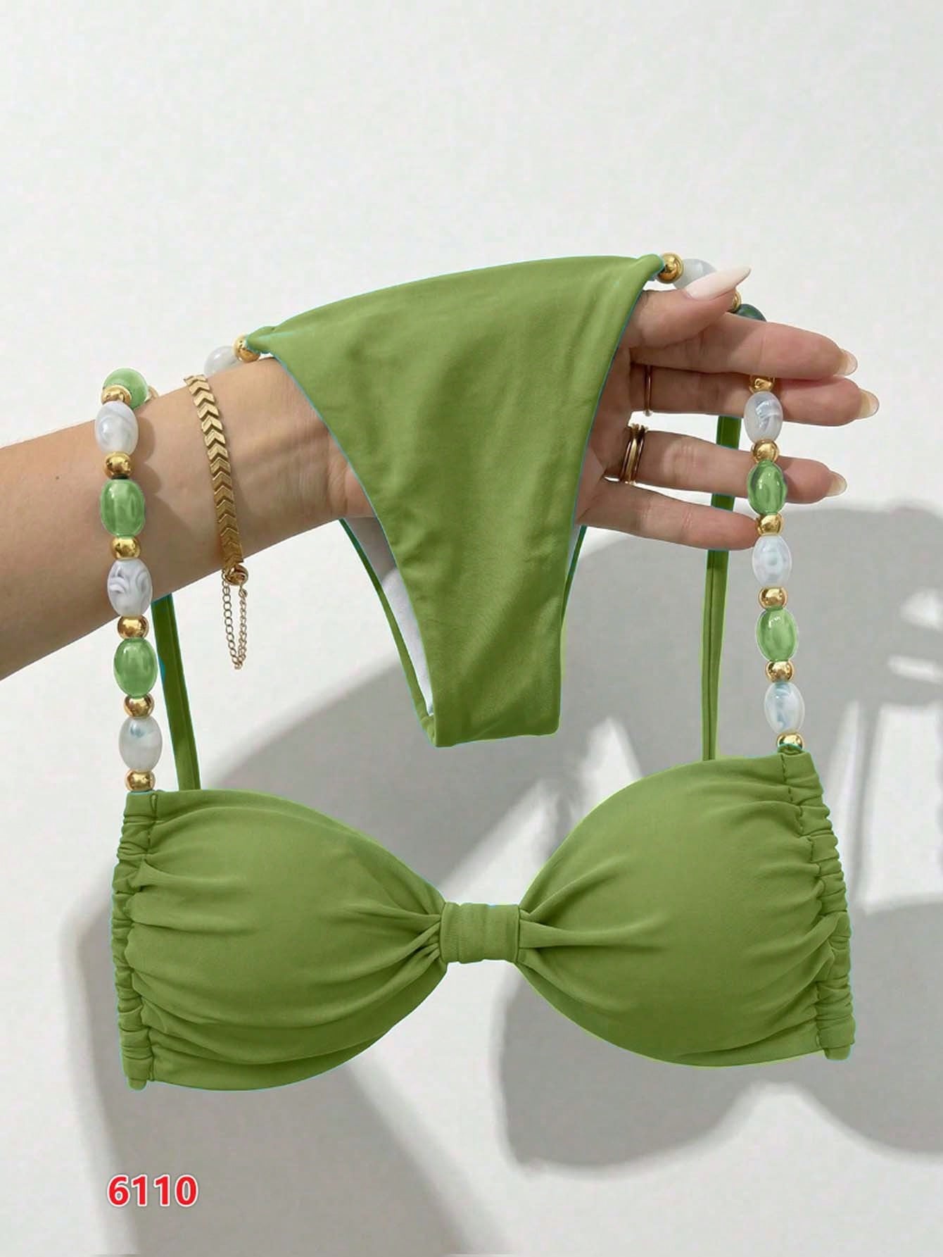 Women's green halter neck bikini set featuring color-block beaded shoulder straps, back tie detail, and high cut bottoms.