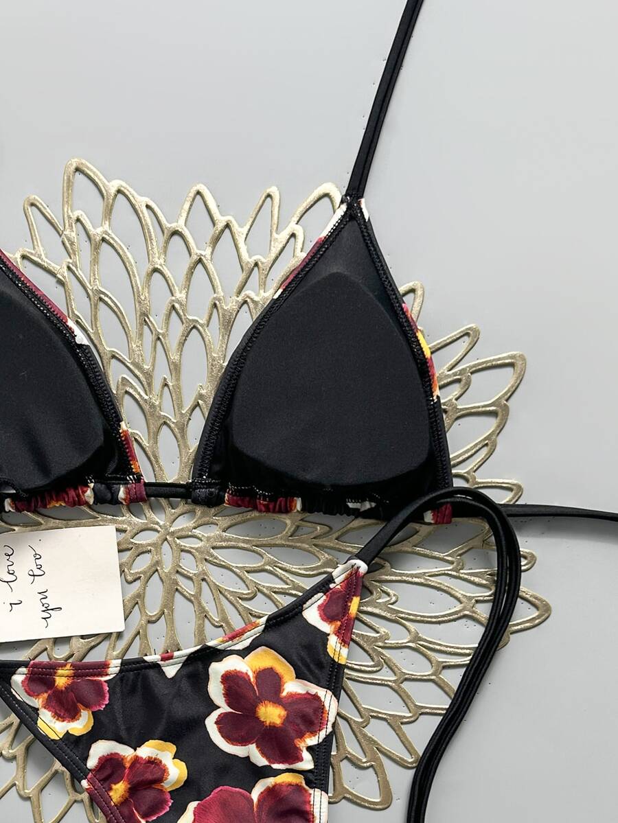 Women's black halter bikini set featuring triangle cups with gold bead decor and tie-back closure