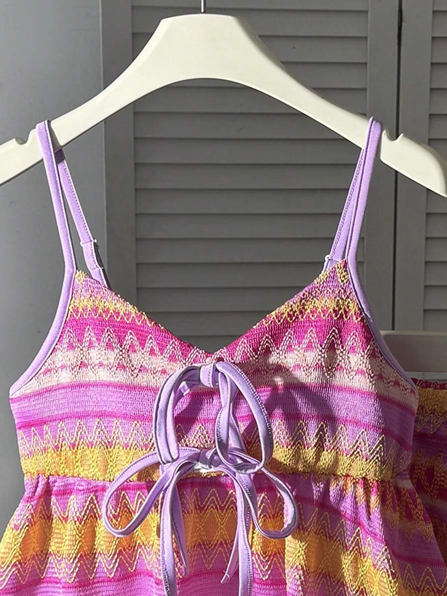 Tween girls 2-piece summer vacation set featuring a multicolored geometric print sleeveless camisole top with bow knot detail and matching elastic waist shorts.