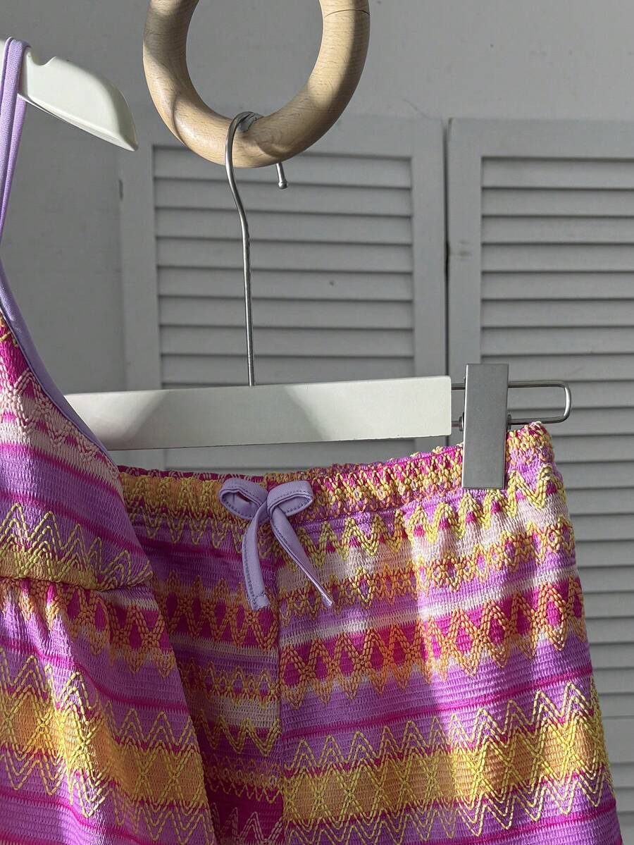 Tween girls 2-piece summer vacation set featuring a multicolored geometric print sleeveless camisole top with bow knot detail and matching elastic waist shorts.