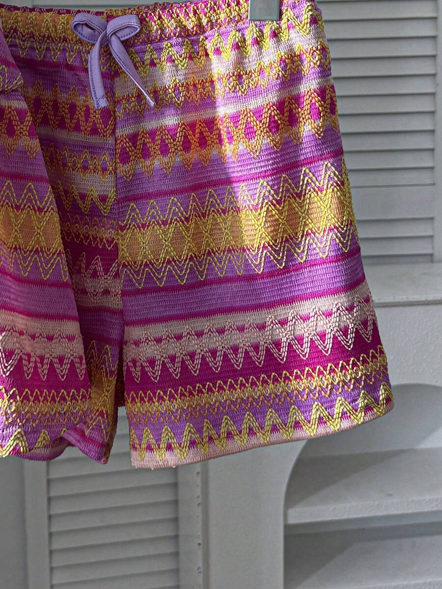 Tween girls 2-piece summer vacation set featuring a multicolored geometric print sleeveless camisole top with bow knot detail and matching elastic waist shorts.