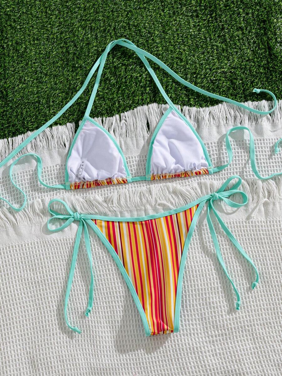 Women's two-piece halter triangle bikini set featuring a backless tie-back top with removable padding and matching tie-side mid-waist bottoms.