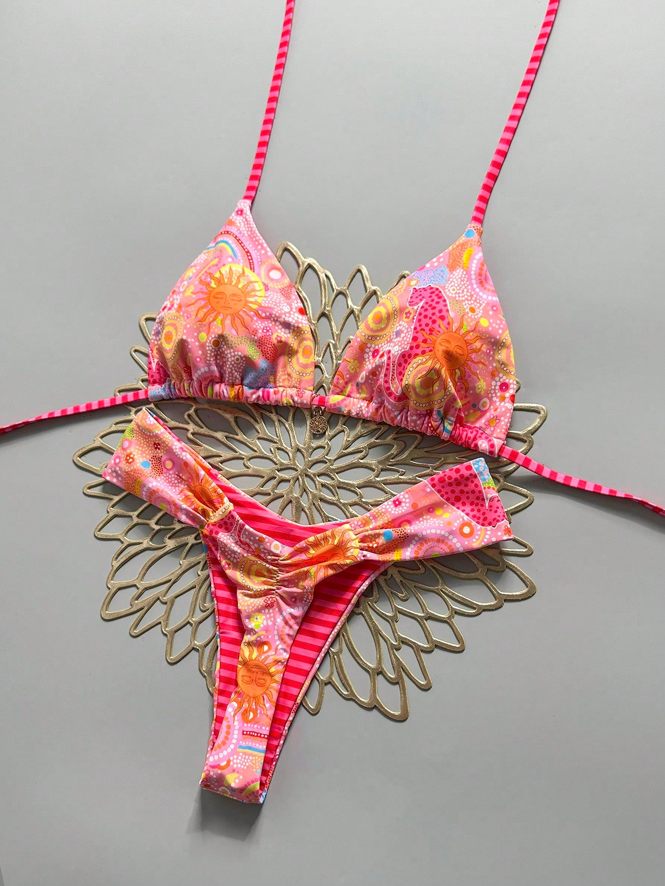 Women's 2-piece triangle cup bikini set in solid color featuring woven pearl shell decoration, halter neckline, and high-waist side-tie ruched bottoms.