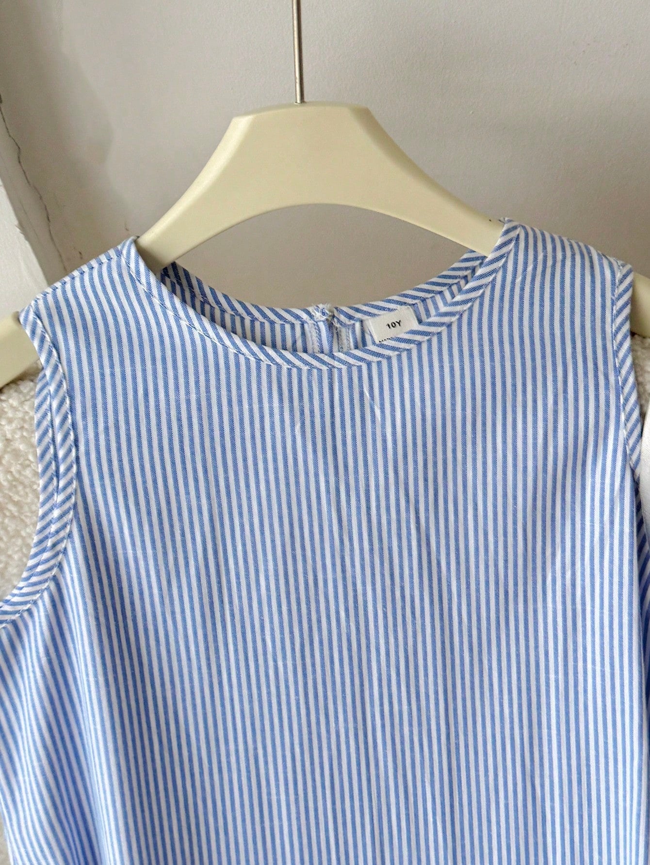 Tween girls sleeveless halter tunic dress with colorful rainbow striped colorblock pattern, button detail, short length, and regular fit for summer vacation or beach wear.