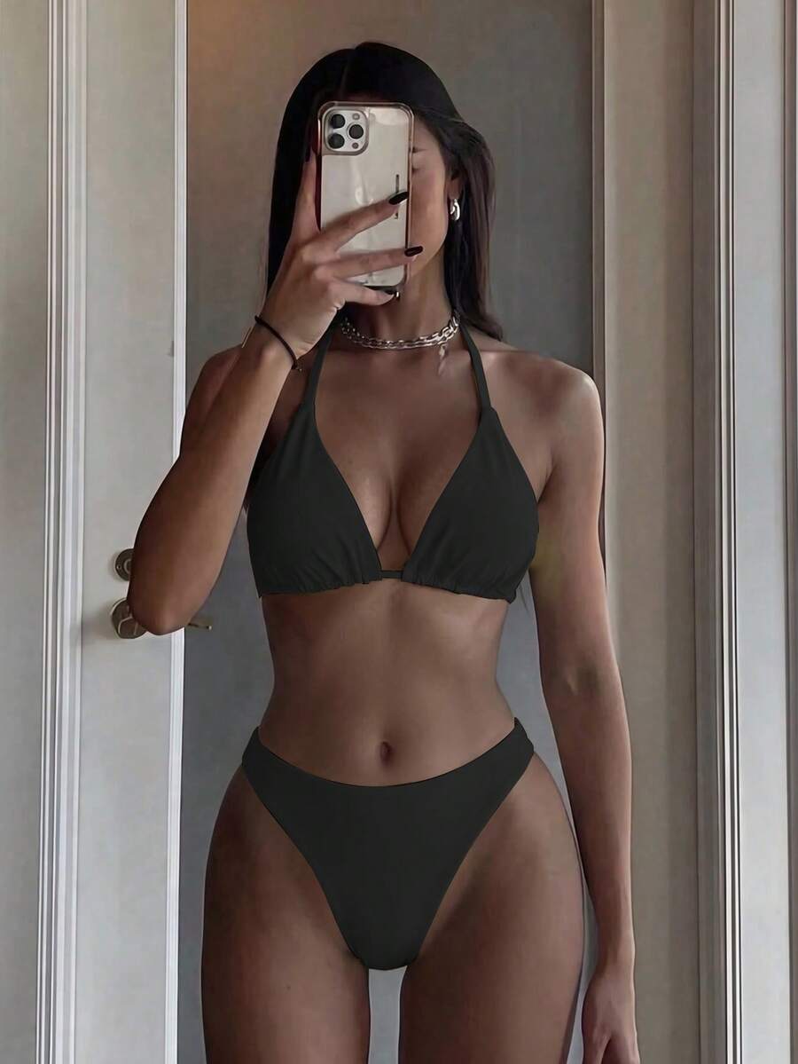 Women's two-piece halter bikini set featuring high cut thong bottoms and removable padding