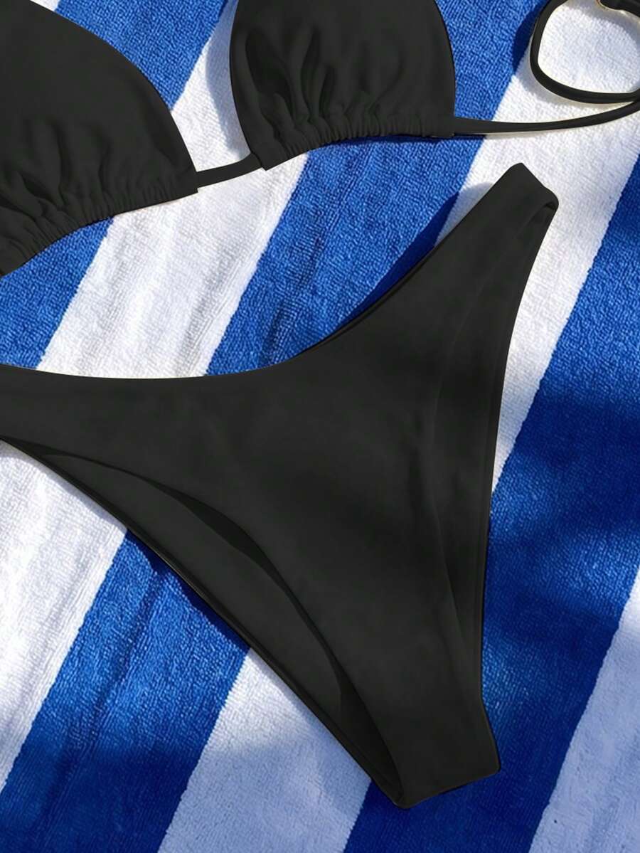 Women's two-piece halter bikini set featuring high cut thong bottoms and removable padding