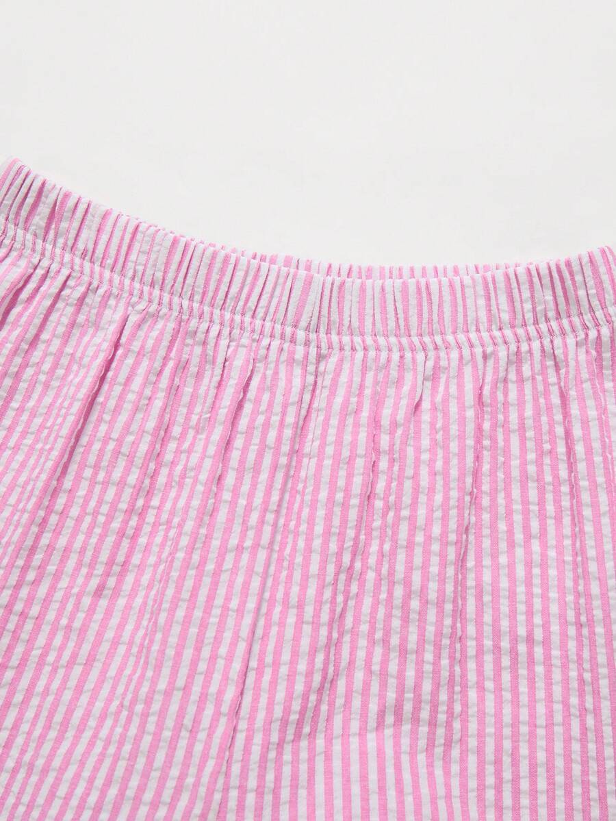 Tween girls 2-piece set featuring a short V-neck ruffle camisole top and matching long pants made of bubble crinkle fabric.