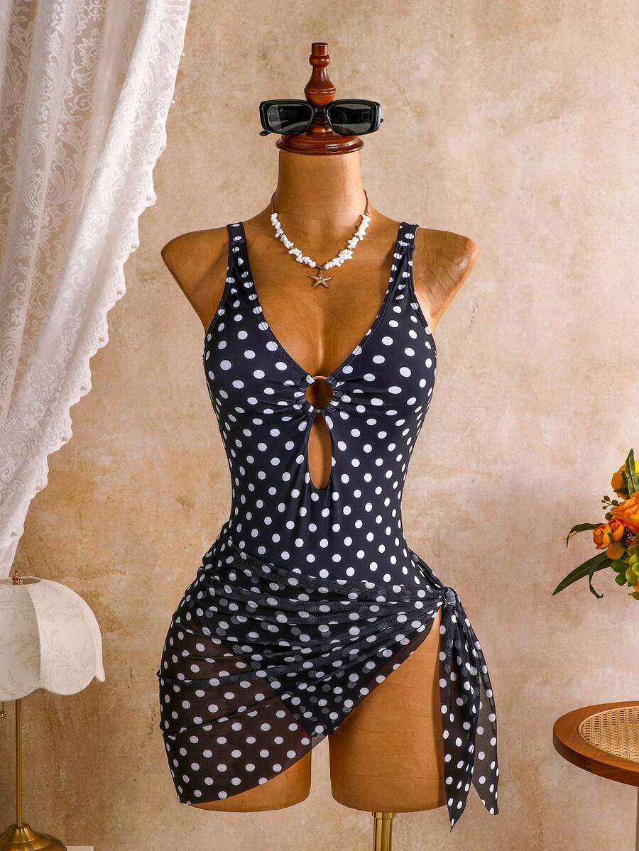 Women's black floral print plunge neck one-piece swimsuit featuring cut-out detail paired with a matching knee-length mesh cover-up skirt