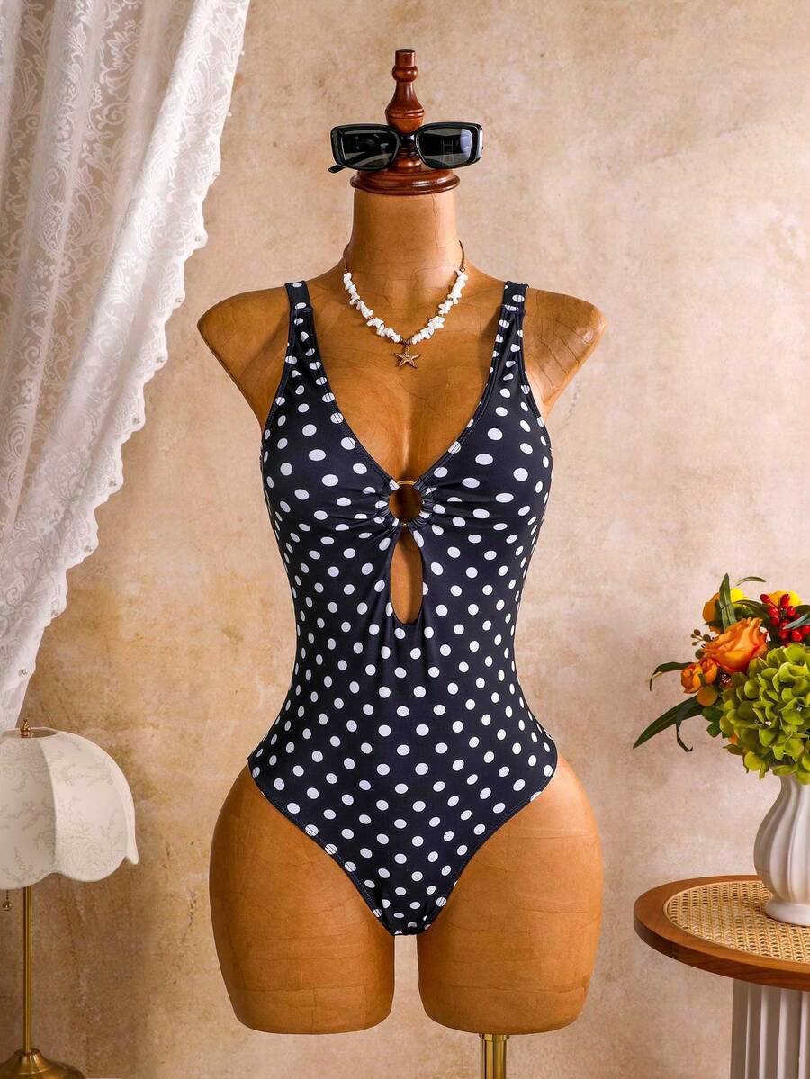 Women's black floral print plunge neck one-piece swimsuit featuring cut-out detail paired with a matching knee-length mesh cover-up skirt
