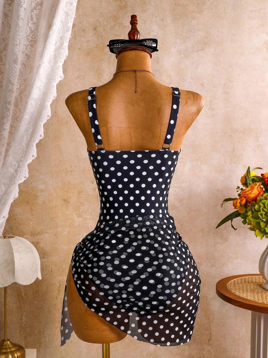 Women's black floral print plunge neck one-piece swimsuit featuring cut-out detail paired with a matching knee-length mesh cover-up skirt