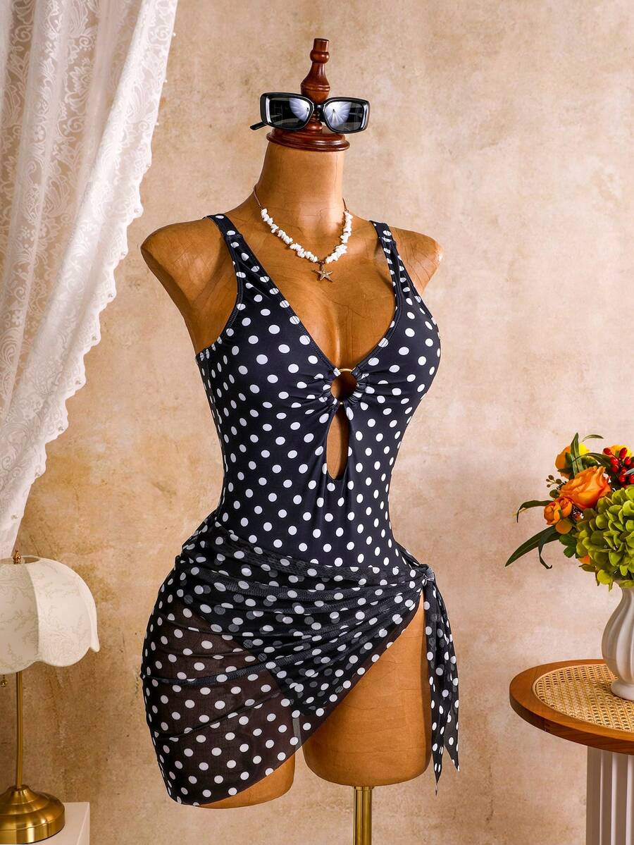 Women's black floral print plunge neck one-piece swimsuit featuring cut-out detail paired with a matching knee-length mesh cover-up skirt