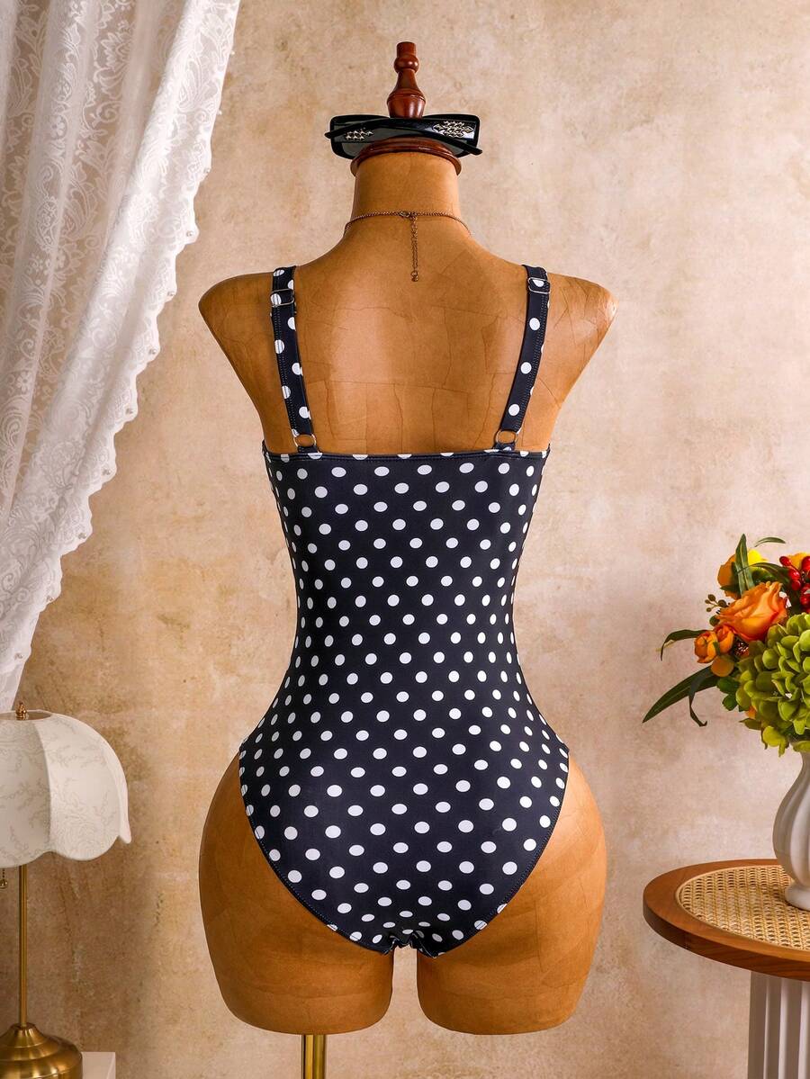 Women's black floral print plunge neck one-piece swimsuit featuring cut-out detail paired with a matching knee-length mesh cover-up skirt
