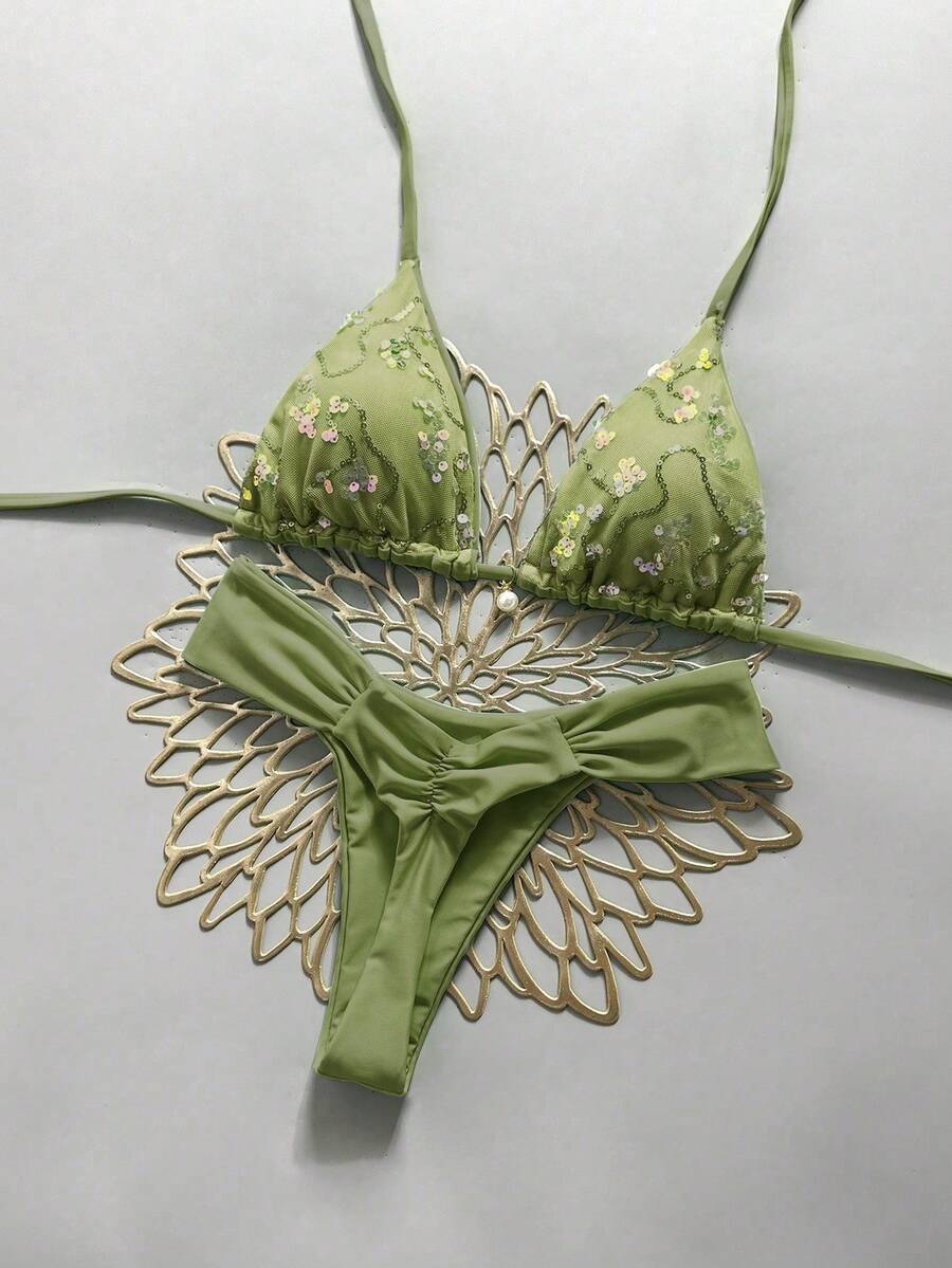 Women's 2-piece triangle cup bikini set in solid color featuring woven pearl shell decoration, halter neckline, and high-waist side-tie ruched bottoms.