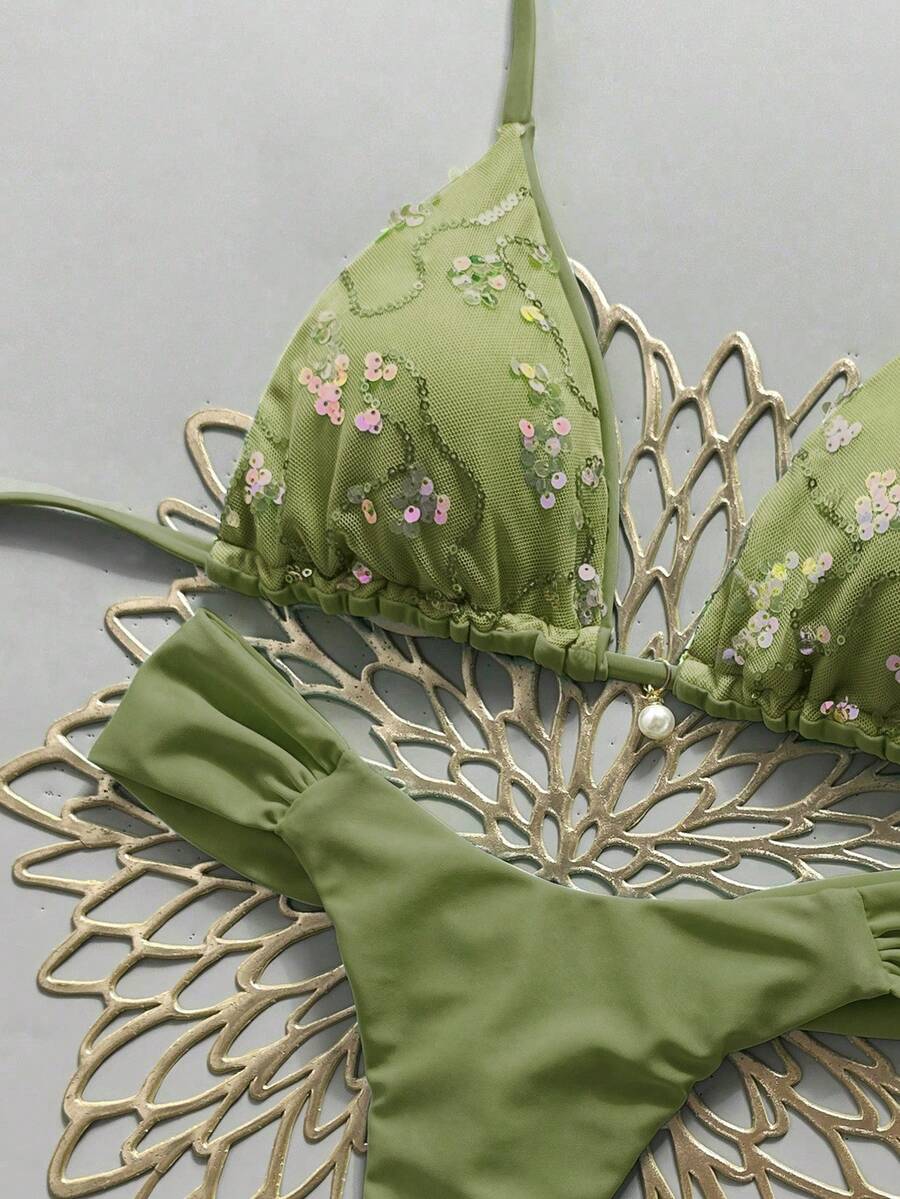 Women's 2-piece triangle cup bikini set in solid color featuring woven pearl shell decoration, halter neckline, and high-waist side-tie ruched bottoms.