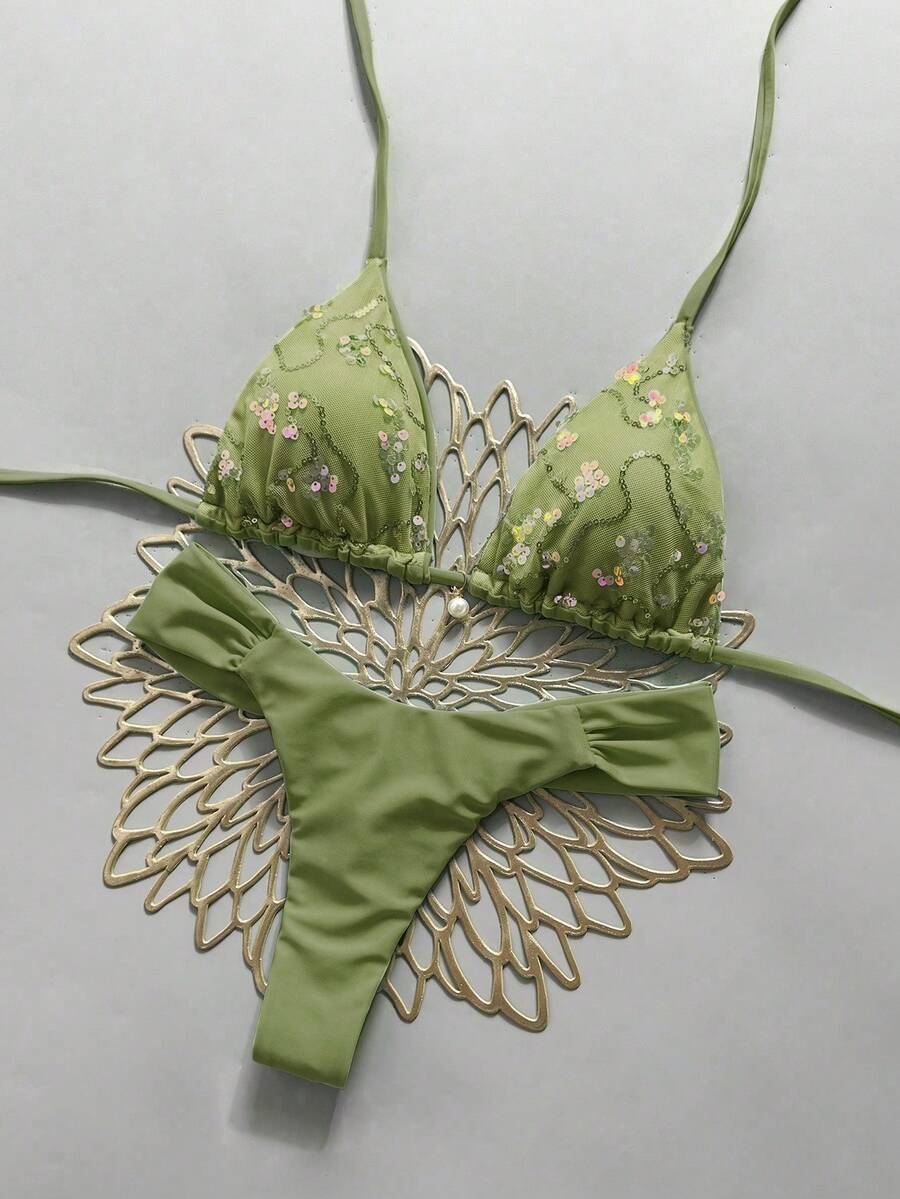 Women's 2-piece triangle cup bikini set in solid color featuring woven pearl shell decoration, halter neckline, and high-waist side-tie ruched bottoms.