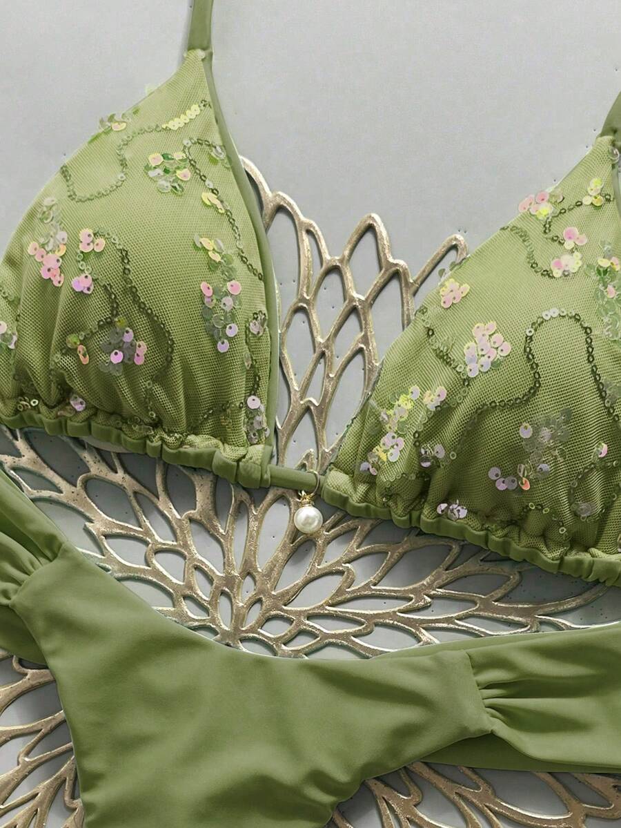 Women's 2-piece triangle cup bikini set in solid color featuring woven pearl shell decoration, halter neckline, and high-waist side-tie ruched bottoms.
