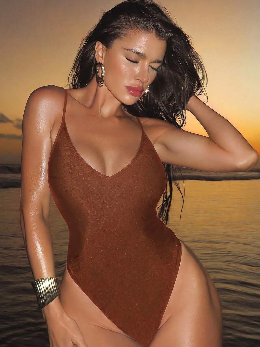 Women's black lace one-piece swimsuit featuring a deep V-neckline, spaghetti straps, backless tie-up detail, and thong bottom.