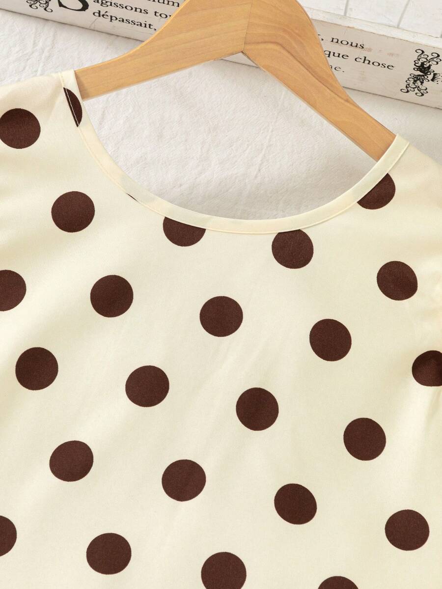 Tween girls apricot vacation midi dress featuring a round neck, cut out details, ruffle flounce accents, and geometric pattern.