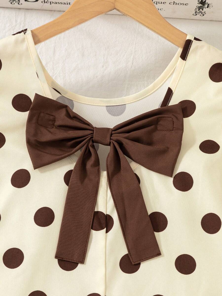 Tween girls apricot vacation midi dress featuring a round neck, cut out details, ruffle flounce accents, and geometric pattern.