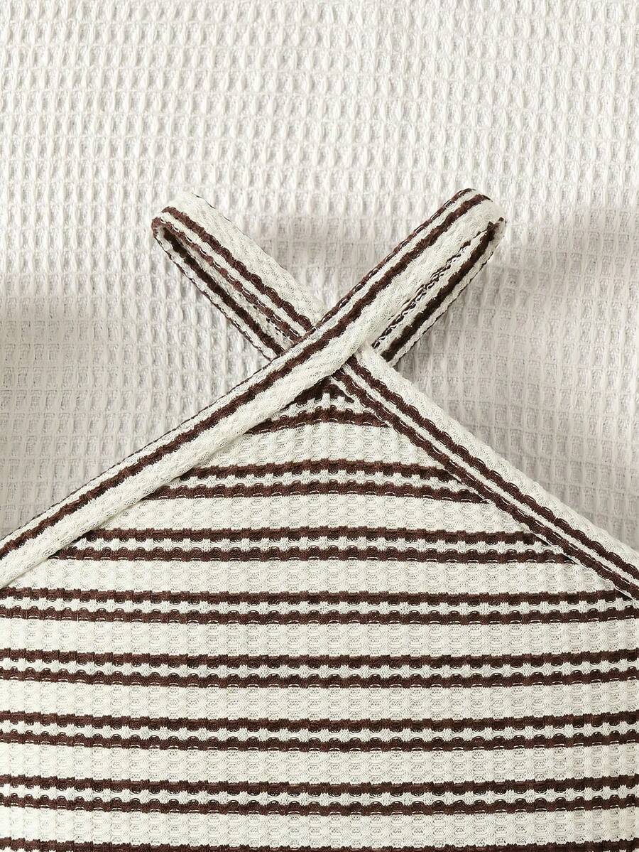 Black and white striped 2-piece set for tween girls featuring a halter sleeveless pullover top with criss-cross knot detail and matching paperbag waist shorts.