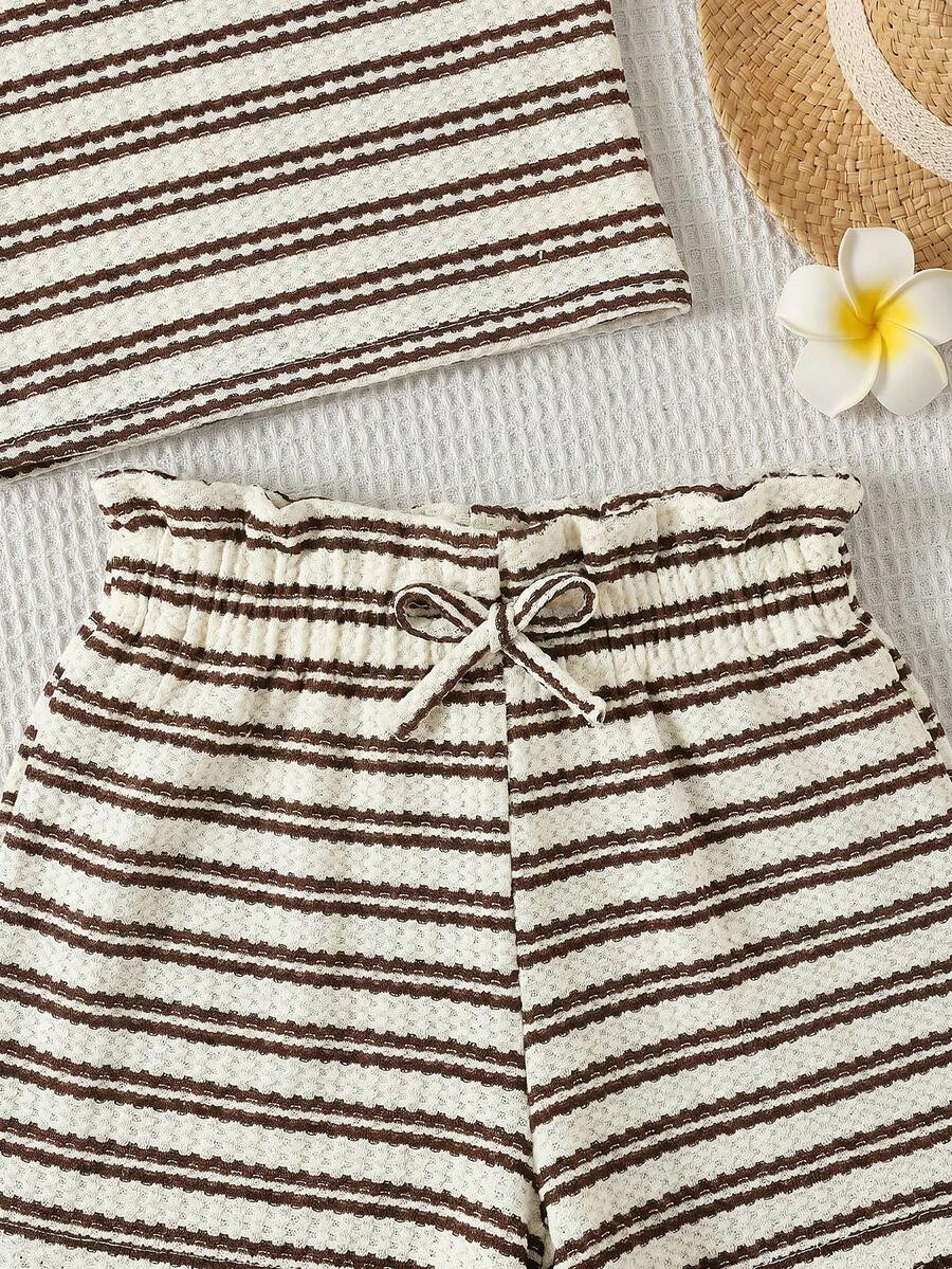 Black and white striped 2-piece set for tween girls featuring a halter sleeveless pullover top with criss-cross knot detail and matching paperbag waist shorts.