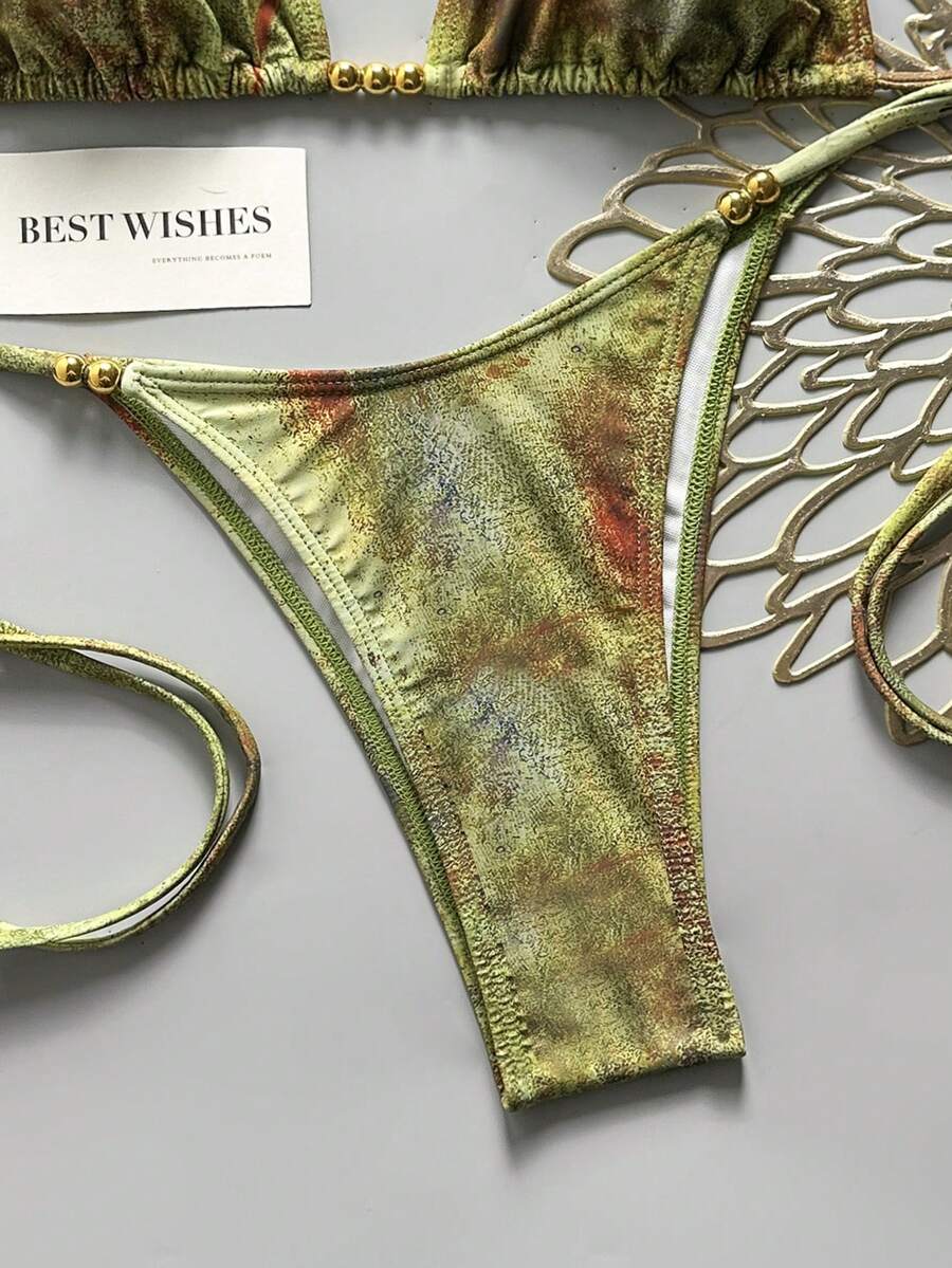 Women's black halter bikini set featuring triangle cups with gold bead decor and tie-back closure