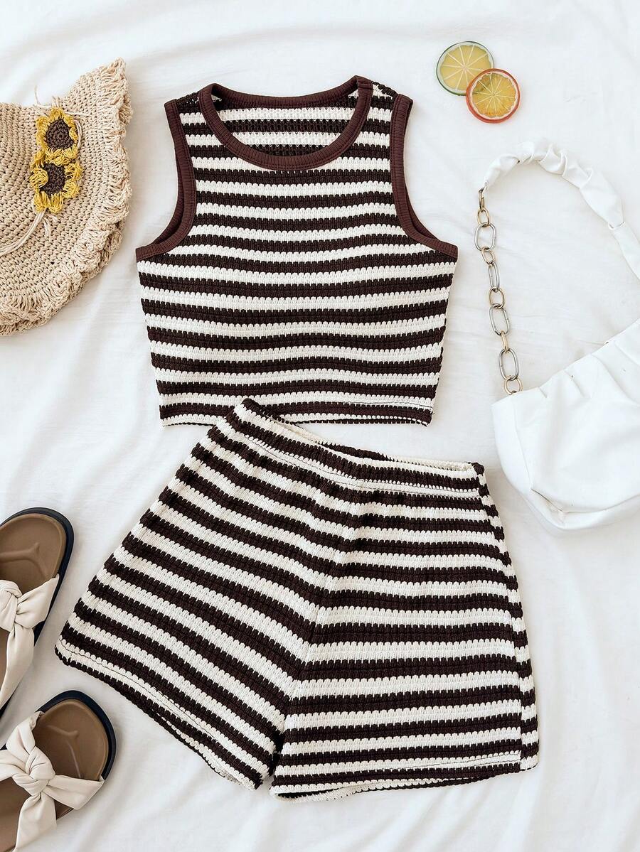 Tween girls black and white two-piece casual summer outfit featuring a rib-knit cropped top with round neck and matching shorts with contrast piping.