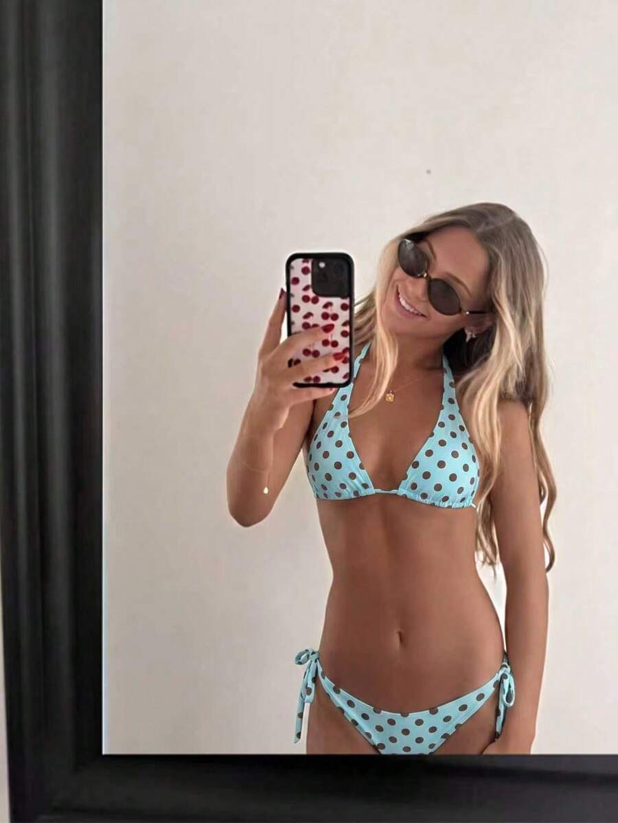 Women's polka dot two-piece bikini set featuring a backless halter top with triangle cups and matching tie-side bottoms.