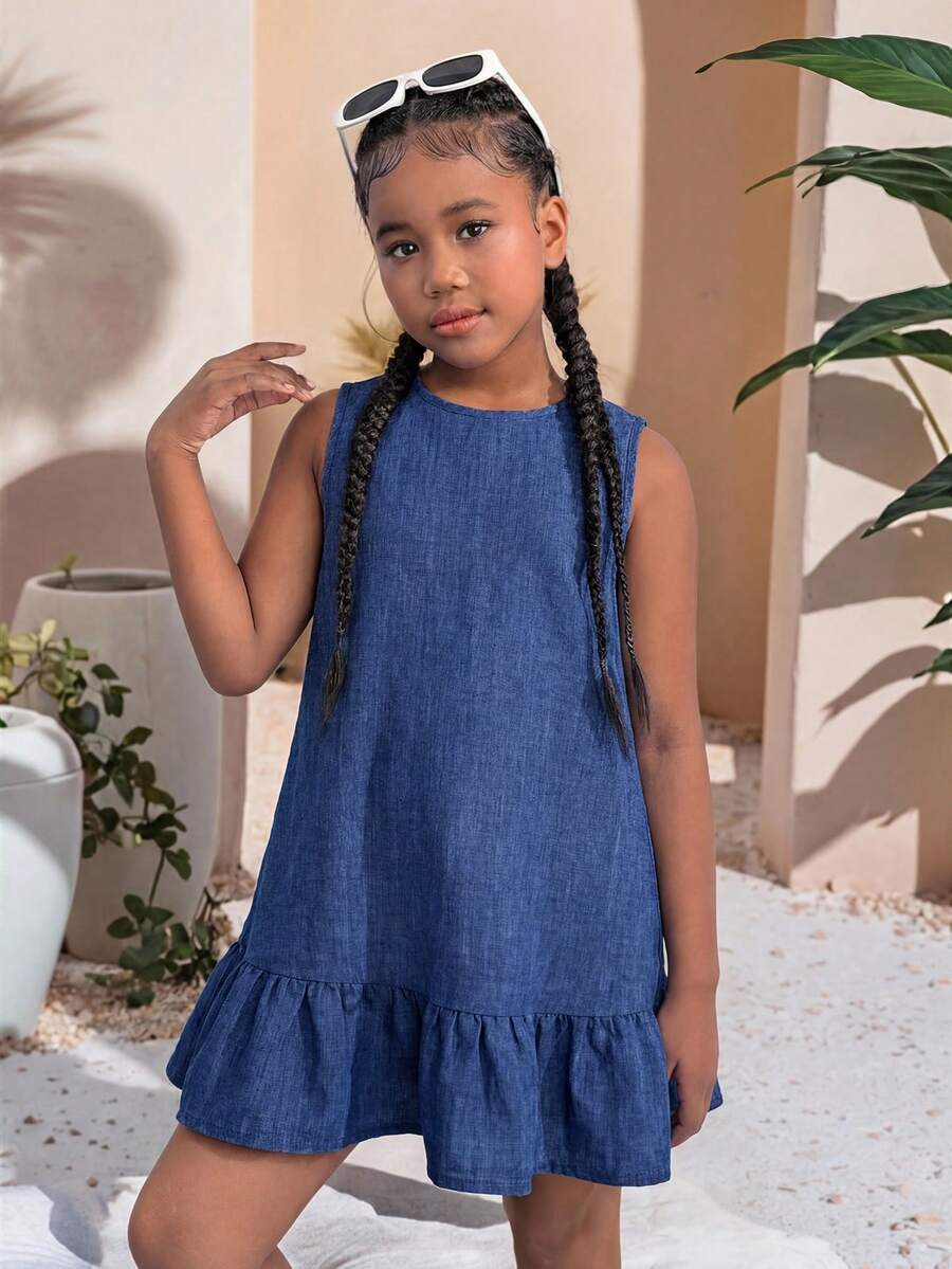 Tween girls blue denim effect sleeveless dress with round neck, button front details, and flounce hem.
