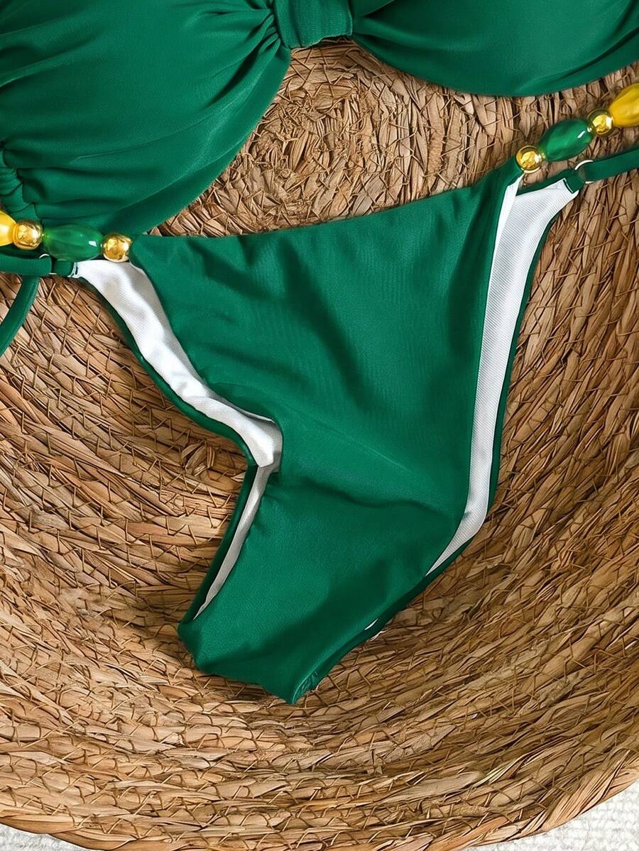 Women's green halter neck bikini set featuring color-block beaded shoulder straps, back tie detail, and high cut bottoms.