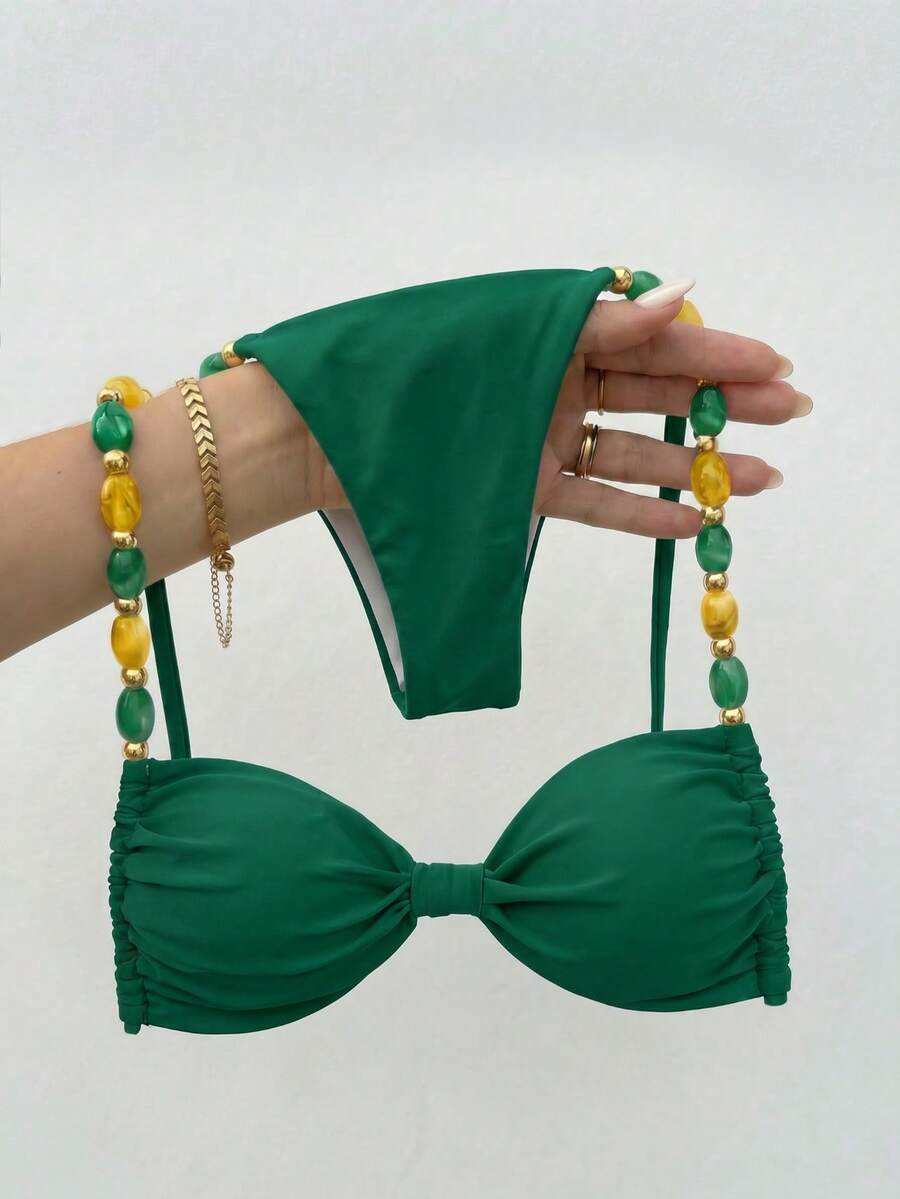 Women's green halter neck bikini set featuring color-block beaded shoulder straps, back tie detail, and high cut bottoms.