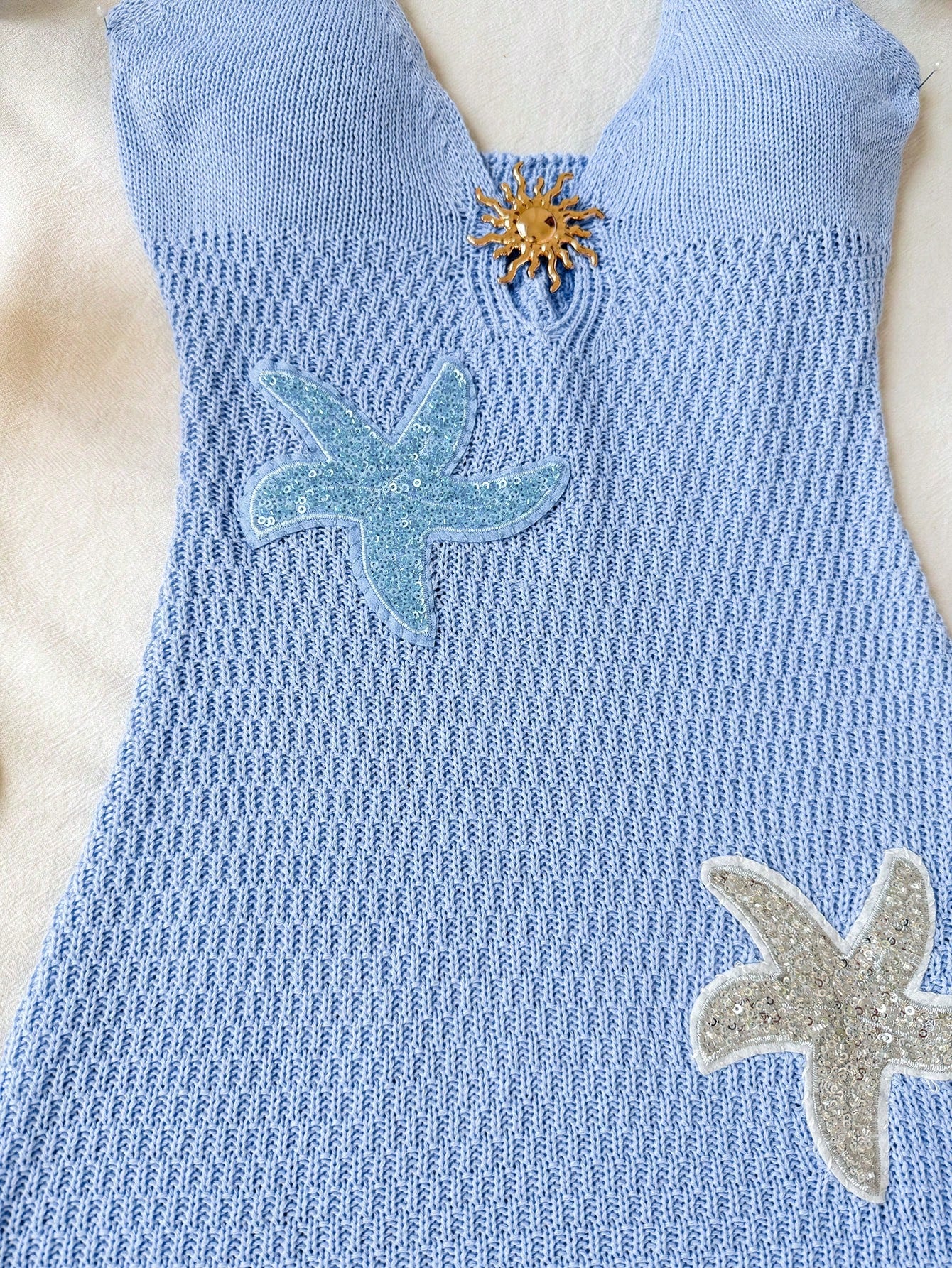 Tween girls long sleeveless halter cover-up dress with ruffle detail, plain fitted design, semi-sheer fabric, and metal starfish decoration.