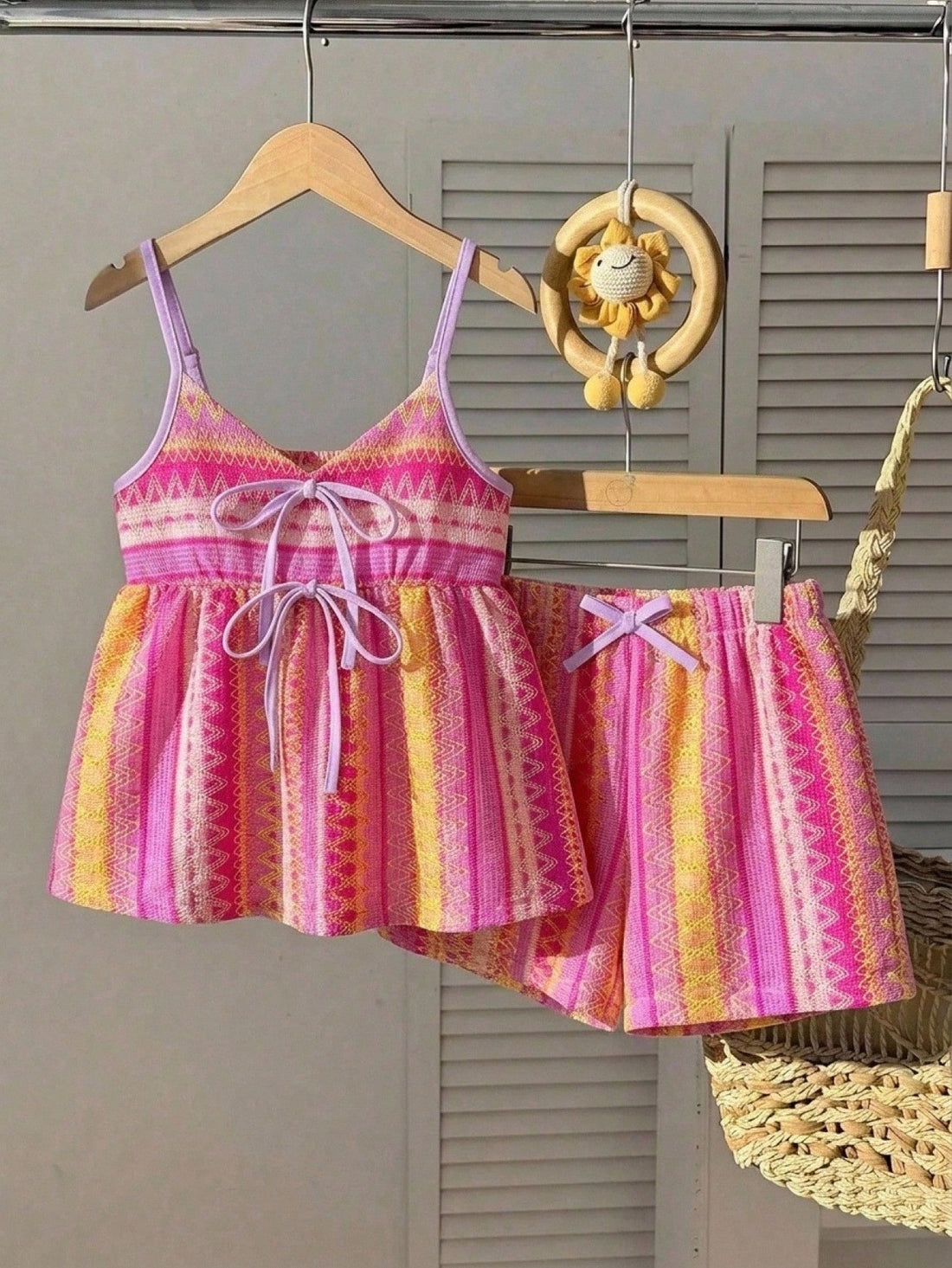 Tween girls 2-piece summer vacation set featuring a multicolored geometric print sleeveless camisole top with bow knot detail and matching elastic waist shorts.